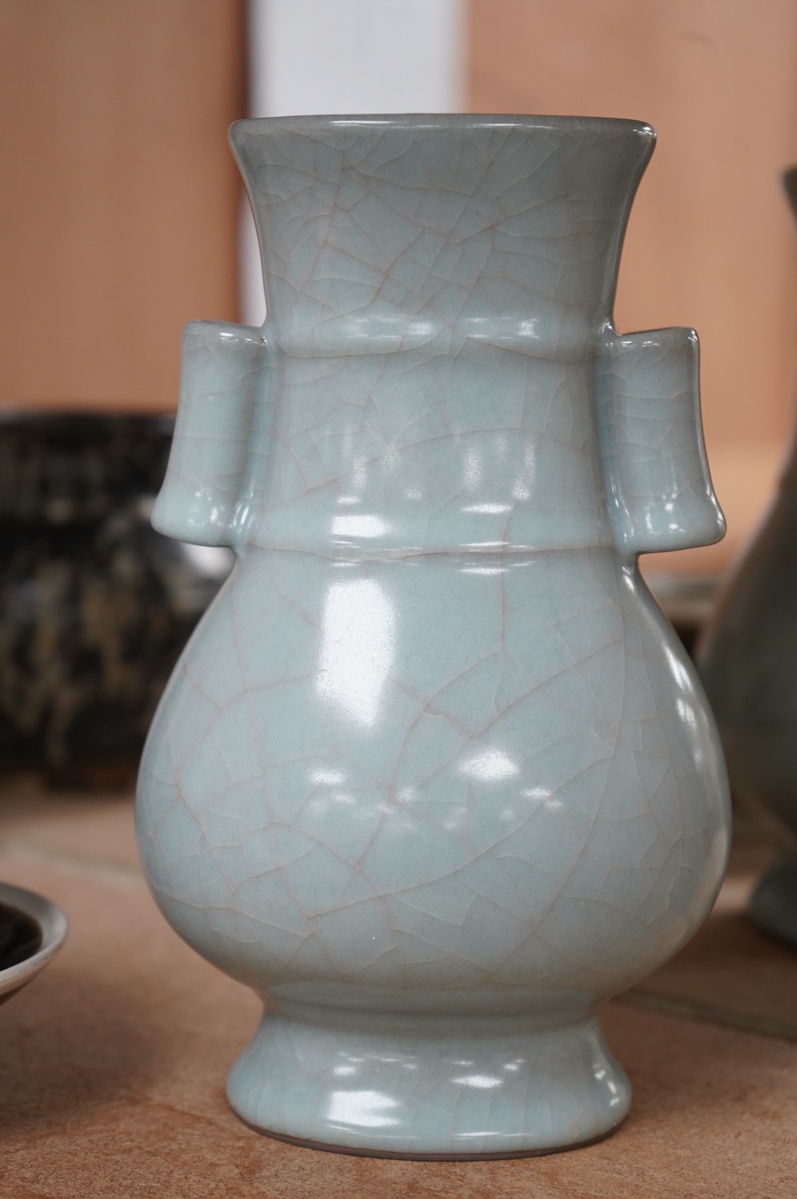 A Chinese crackle glaze arrow vase and a black and russet glazed tea bowl on stand, largest 22cm high